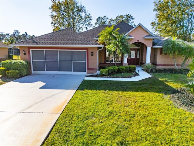 view of front of home with a garage and a front lawn