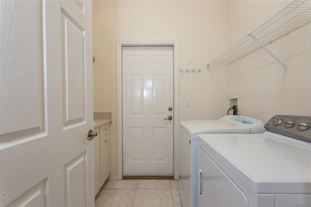 washroom with washer and clothes dryer and light tile patterned flooring