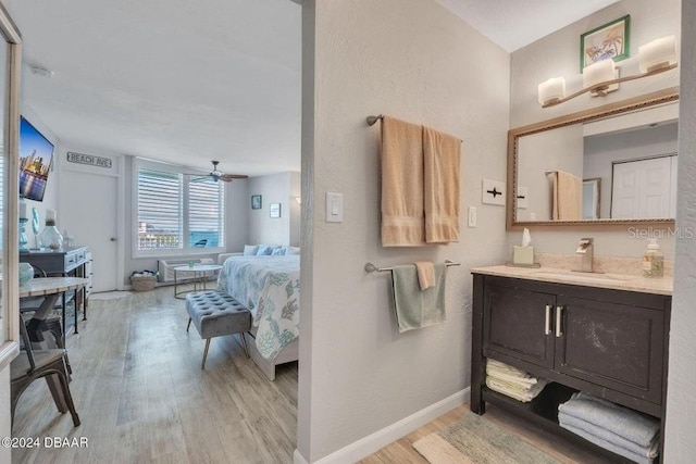 bathroom featuring vanity, hardwood / wood-style flooring, and ceiling fan