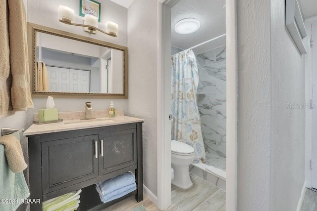 bathroom featuring a shower with shower curtain, vanity, toilet, and wood-type flooring