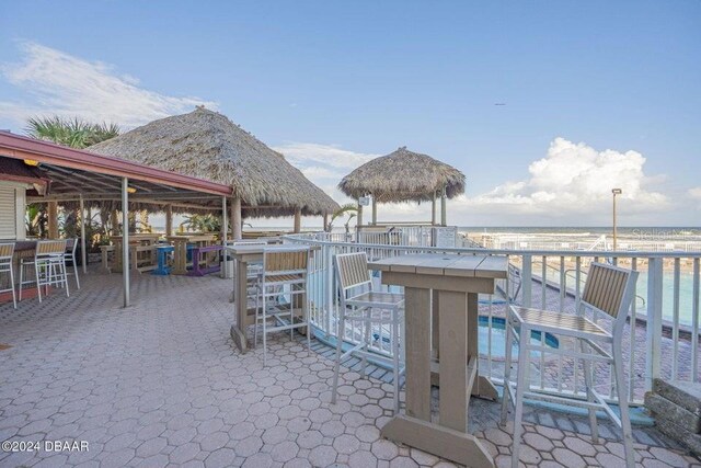 view of patio / terrace with a gazebo, a water view, and an outdoor bar