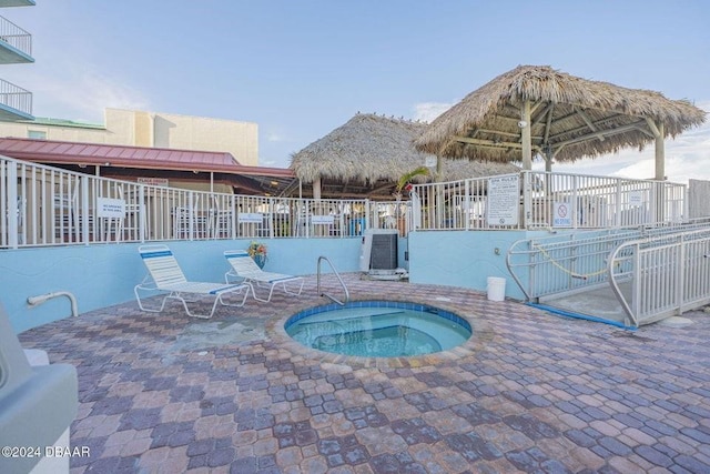 view of pool featuring a gazebo, a community hot tub, and a patio