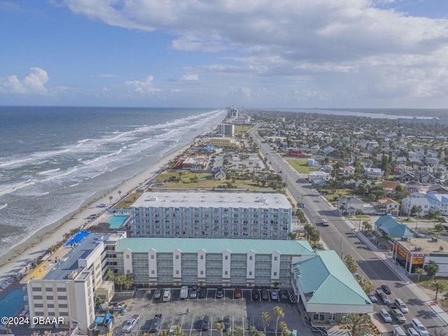 birds eye view of property featuring a view of the beach and a water view