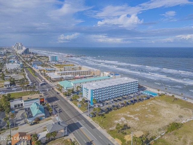 drone / aerial view featuring a water view and a beach view