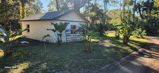 view of property exterior with a yard