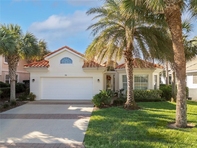 mediterranean / spanish-style house with a garage and a front lawn