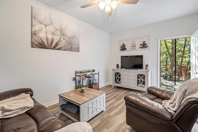 living room featuring light hardwood / wood-style floors and ceiling fan