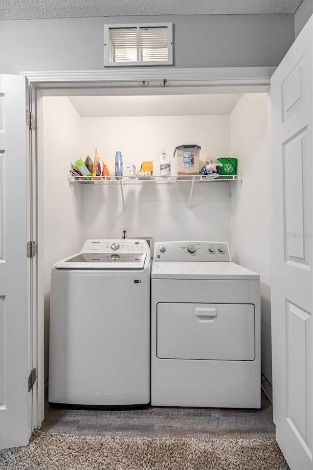 laundry room featuring washing machine and clothes dryer