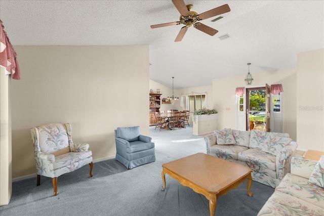 carpeted living room featuring ceiling fan, lofted ceiling, and a textured ceiling