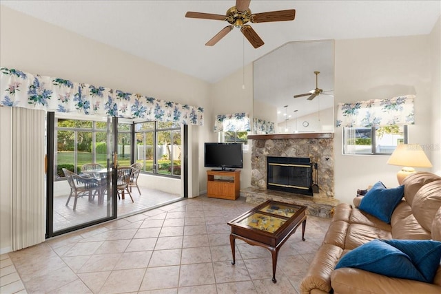 living room with ceiling fan, light tile patterned floors, a fireplace, and high vaulted ceiling