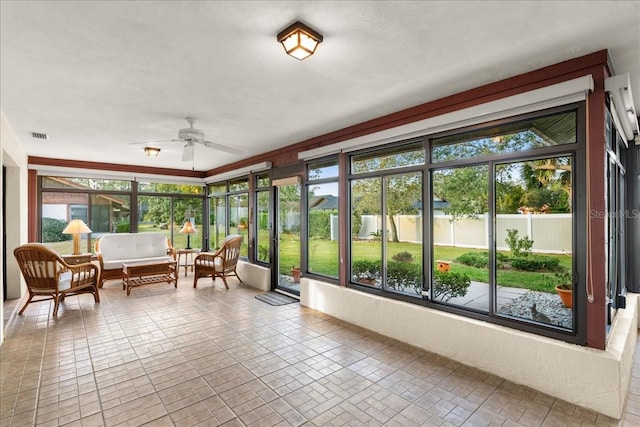 sunroom with ceiling fan and a healthy amount of sunlight