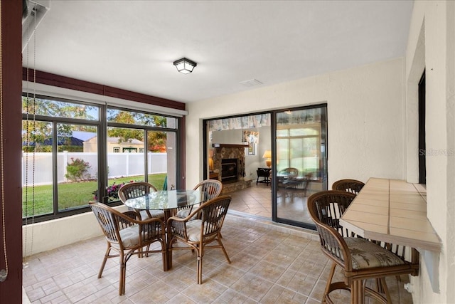 dining space featuring a tile fireplace