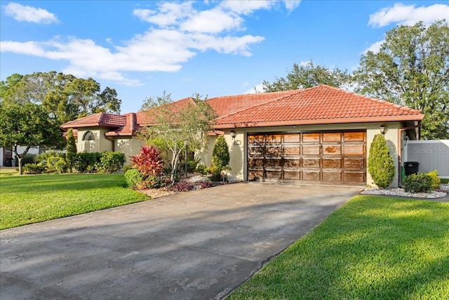 mediterranean / spanish home with a front yard and a garage