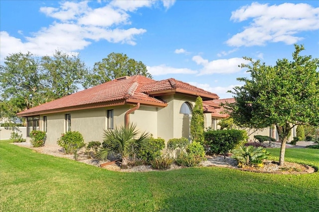 view of property exterior featuring a lawn