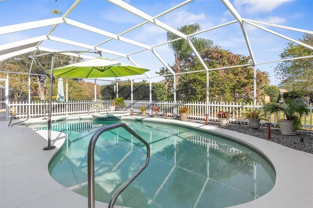 view of swimming pool featuring glass enclosure and a patio area