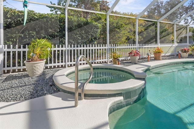 view of pool with an in ground hot tub and a lanai