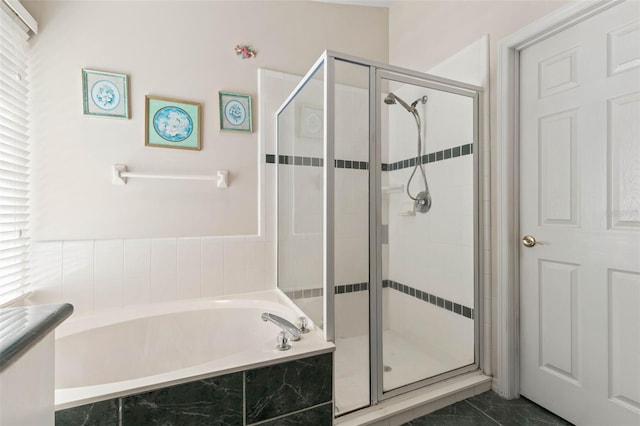 bathroom featuring plenty of natural light and plus walk in shower