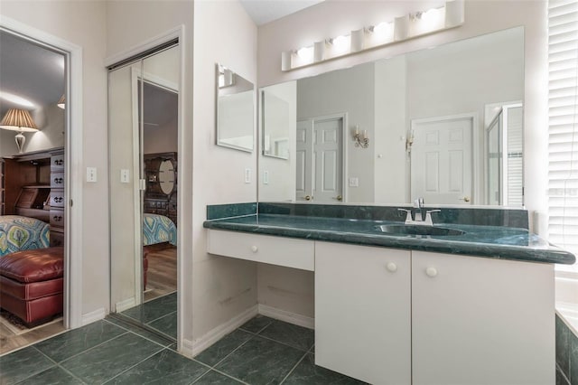 bathroom featuring tile patterned flooring and vanity