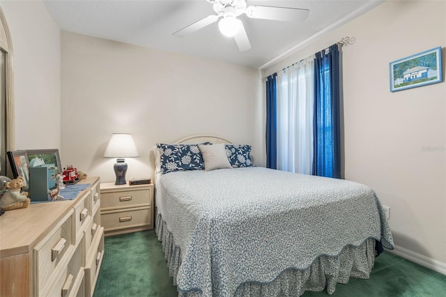 bedroom featuring ceiling fan and dark carpet