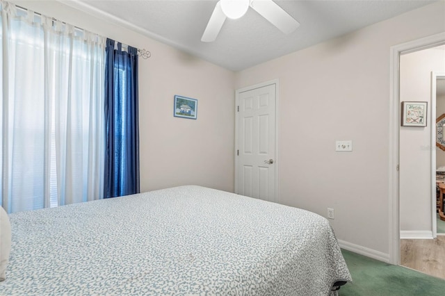 carpeted bedroom featuring ceiling fan