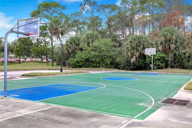 view of sport court featuring a yard