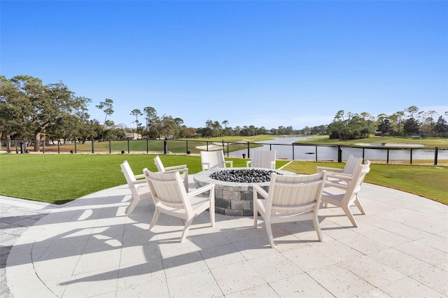 view of patio with a water view and a fire pit