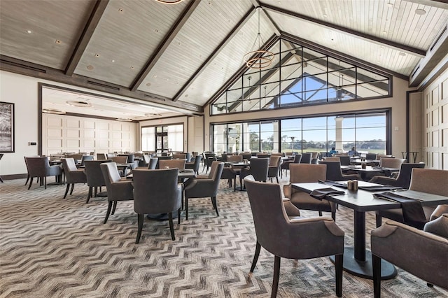 carpeted dining area featuring beam ceiling, wooden ceiling, and high vaulted ceiling