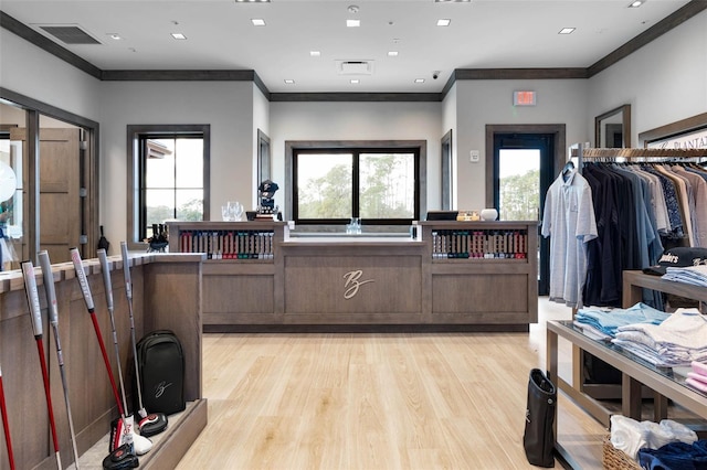 interior space featuring crown molding and light hardwood / wood-style flooring