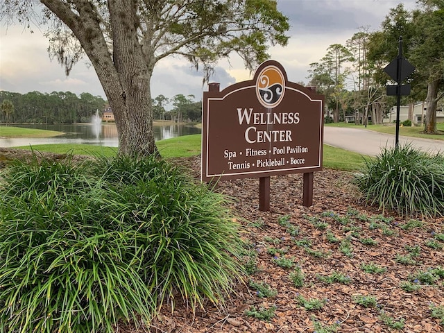 community / neighborhood sign with a water view