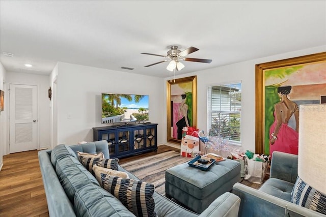 living room featuring hardwood / wood-style floors and ceiling fan