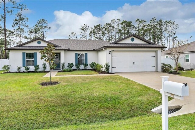 ranch-style house featuring a garage and a front yard