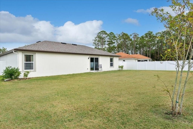 back of house featuring a lawn