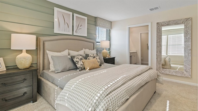 carpeted bedroom featuring connected bathroom