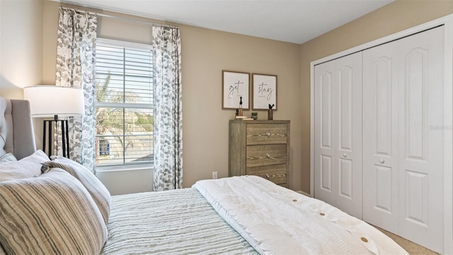 bedroom featuring multiple windows, a closet, and carpet