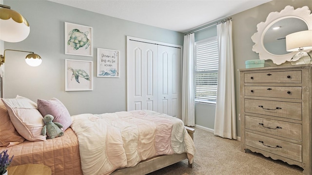 bedroom featuring light colored carpet and a closet