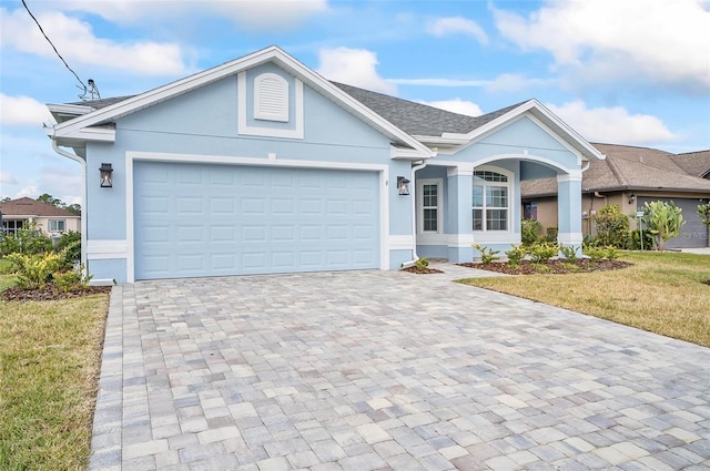 view of front of house featuring a front yard and a garage