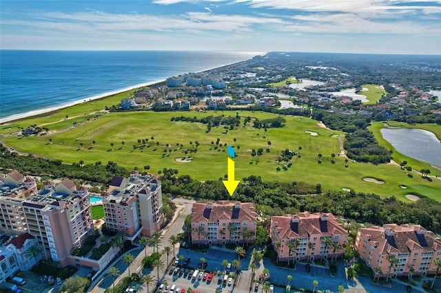 birds eye view of property with a view of the beach and a water view