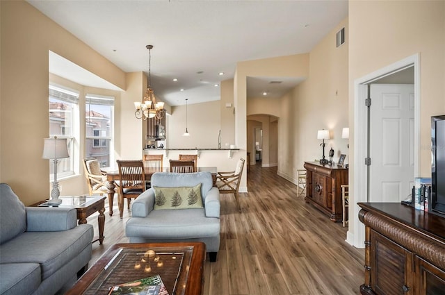 living room with wood-type flooring and a notable chandelier