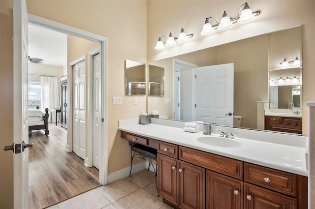 bathroom with hardwood / wood-style floors, vanity, and an enclosed shower