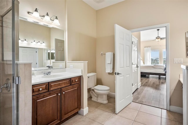 bathroom with ceiling fan, walk in shower, tile patterned floors, toilet, and vanity