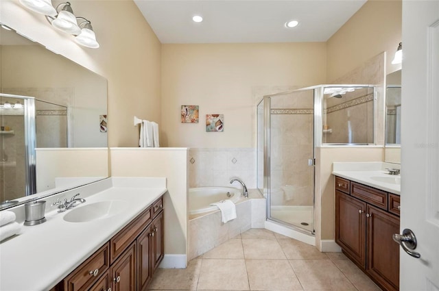 bathroom with tile patterned floors, vanity, and separate shower and tub