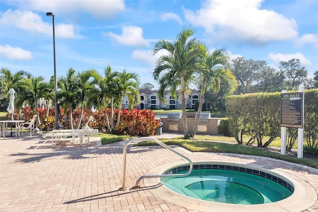 view of swimming pool with a community hot tub