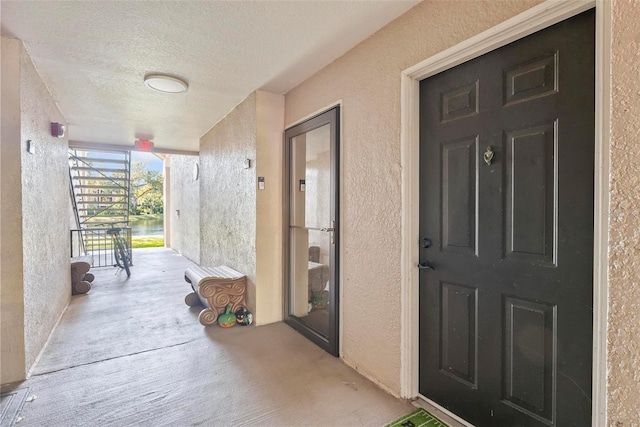 view of exterior entry with covered porch