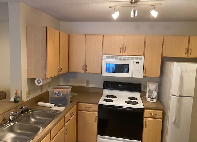 kitchen featuring a textured ceiling, light brown cabinets, white appliances, and sink