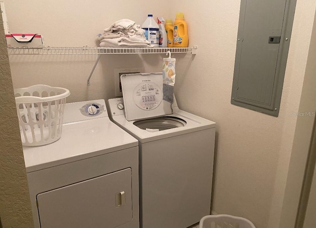 clothes washing area with electric panel and independent washer and dryer