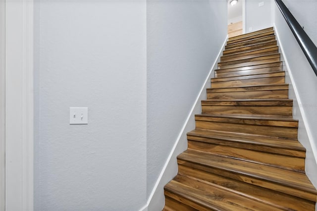 staircase with wood-type flooring