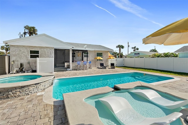 view of swimming pool with an in ground hot tub and a patio area