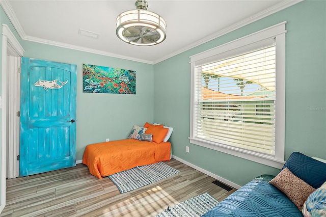 bedroom featuring light wood-type flooring and ornamental molding