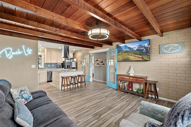 living room featuring beamed ceiling, light hardwood / wood-style floors, and wooden ceiling