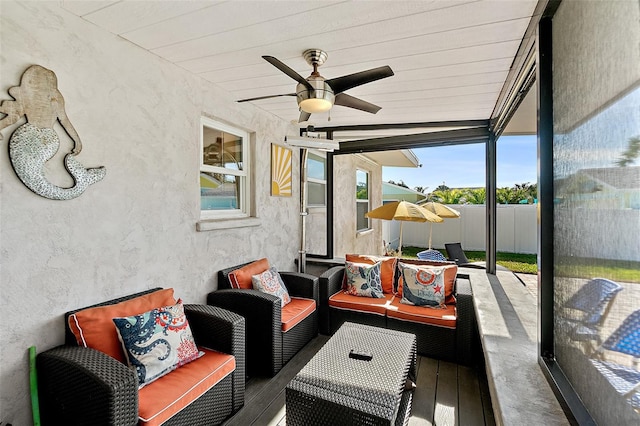 sunroom featuring ceiling fan